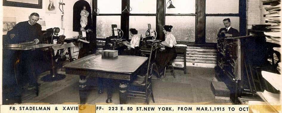 Picture of a room with four people working in it circa 1915