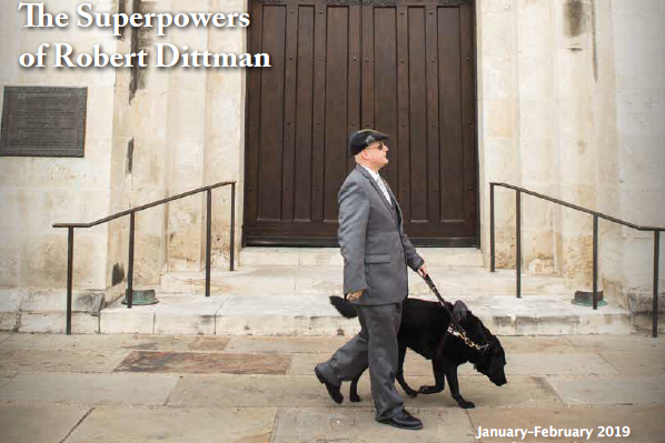 Robert pictured with his guide dog walking down the street